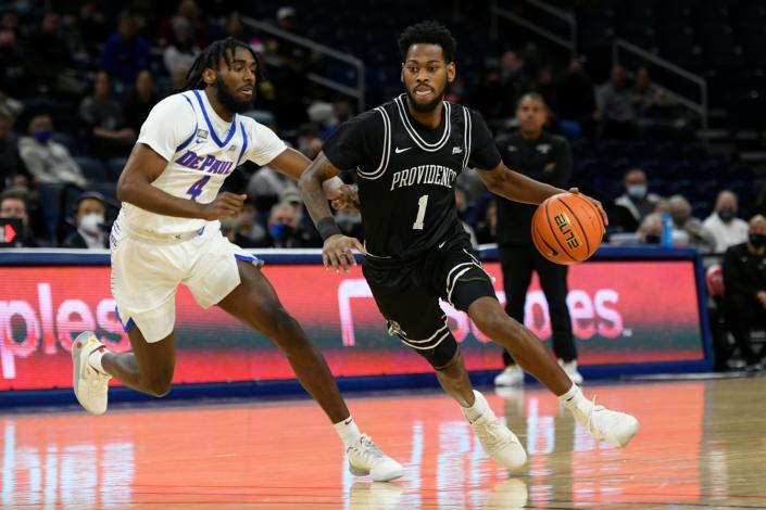 Providence&#39;s Al Durham (1) drives against DePaul&#39;s Javon Liberty-Freeman during Saturday&#39;s game in Chicago. Providence won, 70-53.