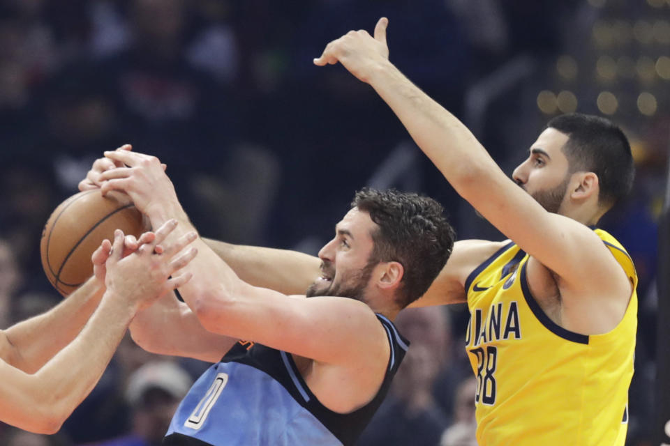 Cleveland Cavaliers' Kevin Love, left, and Indiana Pacers' Goga Bitadze battle or a rebound in the first half of an NBA basketball game, Saturday, Feb. 29, 2020, in Cleveland. (AP Photo/Tony Dejak)