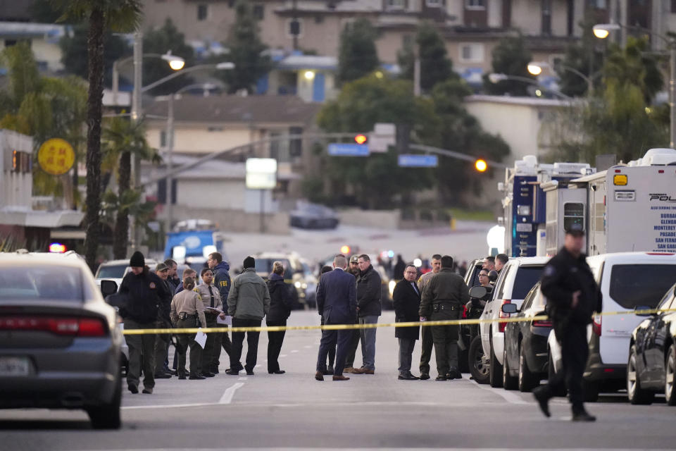 Law enforcement personnel gather outside a ballroom dance club in Monterey Park, Calif., Sunday, Jan. 22, 2023. A mass shooting took place at the dance club following a Lunar New Year celebration, setting off a manhunt for the suspect. (AP Photo/Jae C. Hong)