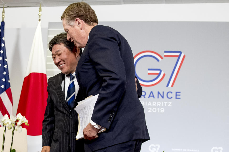 Japanese Economy Minister Toshimitsu Motegi, left, shakes hands with U.S. Trade Representative Robert Lighthizer, right, following a news conference at the G-7 summit in Biarritz, France, Sunday, Aug. 25, 2019, where President Donald Trump and Japanese Prime Minister Shinzo Abe announced that the U.S. and Japan have agreed in principle on a new trade agreement. (AP Photo/Andrew Harnik)