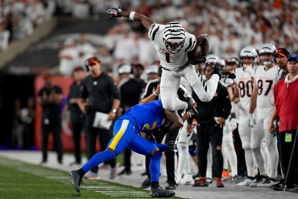 Cincinnati Bengals wide receiver Ja'Marr Chase (1) leaps over Los Angeles Rams safety Russ Yeast (2) on a catch down the sideline in the fourth quarter of the NFL Week 3 game between the Cincinnati Bengals and the Los Angeles Rams at Paycor Stadium in downtown Cincinnati on Monday, Sept. 25, 2023. The Bengals beat the Rams, 19-16, improving to 1-2.