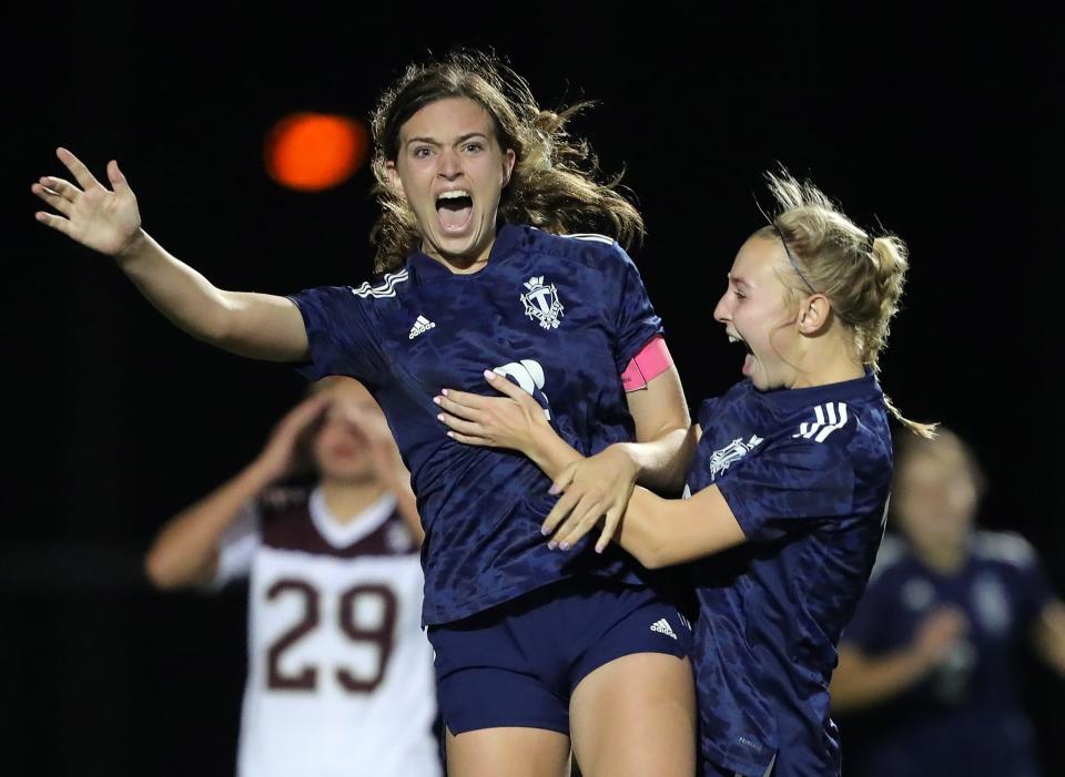 Twinsburg's Brenna Utrup, left, celebrates her game-winning goal with Olivia Zelenka in overtime of a Division I district semifinal soccer game against the Stow Bulldogs, Monday, Oct. 24, 2022, in Twinsburg, Ohio.