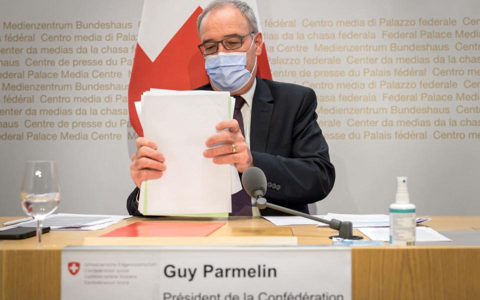 Swiss President Guy Parmelin collects his documents at the end of a press conference on a long-delayed Swiss-EU framework deal on May 26, 2021 in Bern. - AFP