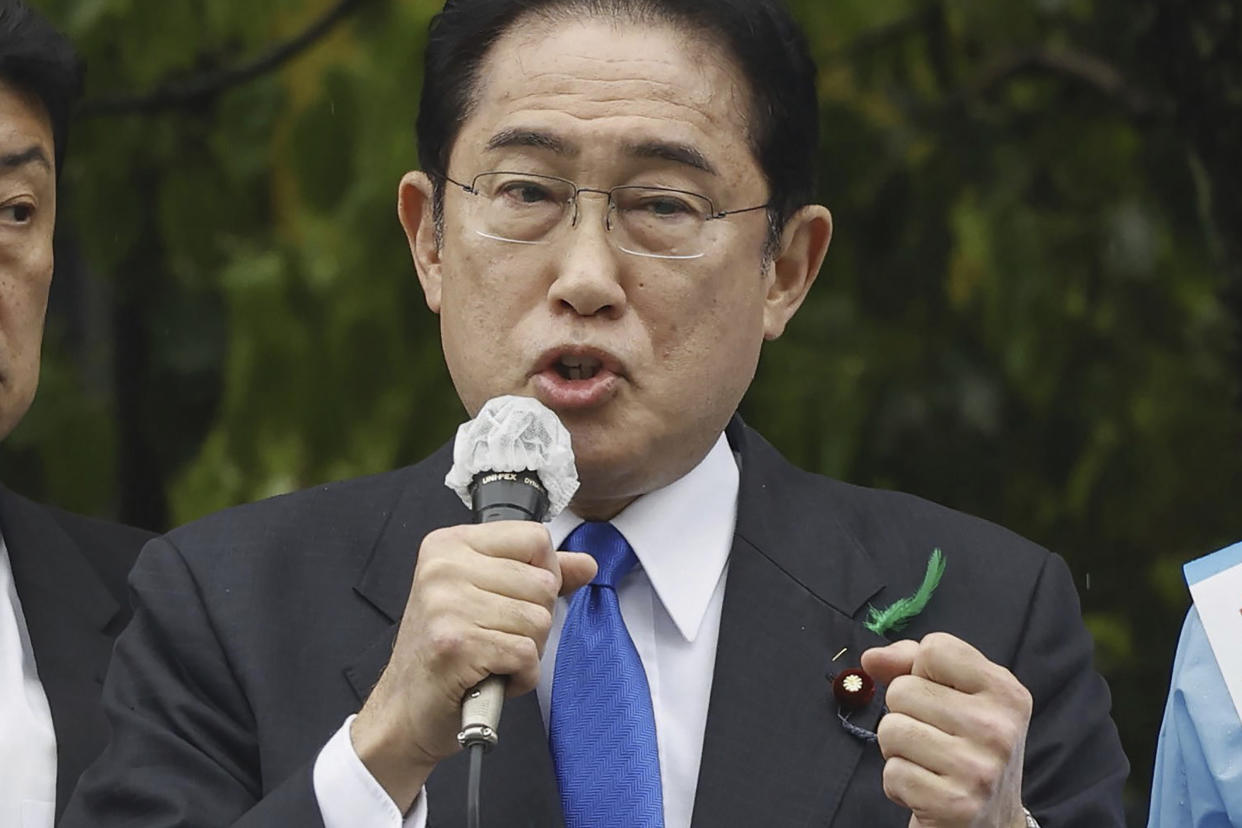 Japanese Prime Minister Fumio Kishida delivers a speech to support his ruling party’s candidate in a local election, near a train station in Wakayama, western Japan Saturday, April 15, 2023. Kishida was evacuated unharmed after an explosion at a western port on Saturday, NHK television reported, and a suspect was apprehended for allegedly throwing the explosive. (Kyodo News via AP)