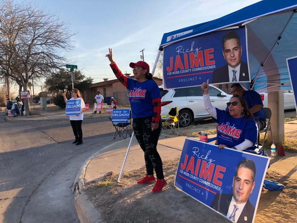 Democratic activists cheer on voters in Laredo, Texas, during Tuesday's primaries. Longtime Democratic Rep. Henry Cuellar will face opponent Jessica Cisneros in a runoff in May.