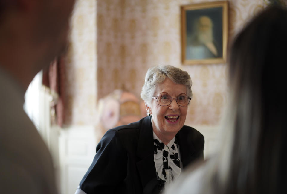 Kathy Goodwin, a volunteer at the Historic Shiloh House, gives a tour of the first floor of the 25-room mansion once owned by Zion's founder, John Alexander Dowie, on Thursday, Sept. 15, 2022. Goodwin tells the visitors of her grandfather, a master carpenter from Switzerland who heard Dowie speak in Chicago and decided to move his family north to help the preacher build the city of Zion. (AP Photo/Jessie Wardarski)