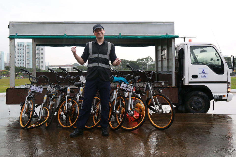 All in a day’s work. Zhivko Girginov poses with some the rental bicycles he collected on Tuesday (12 December). (PHOTO: Dhany Osman / Yahoo News Singapore)