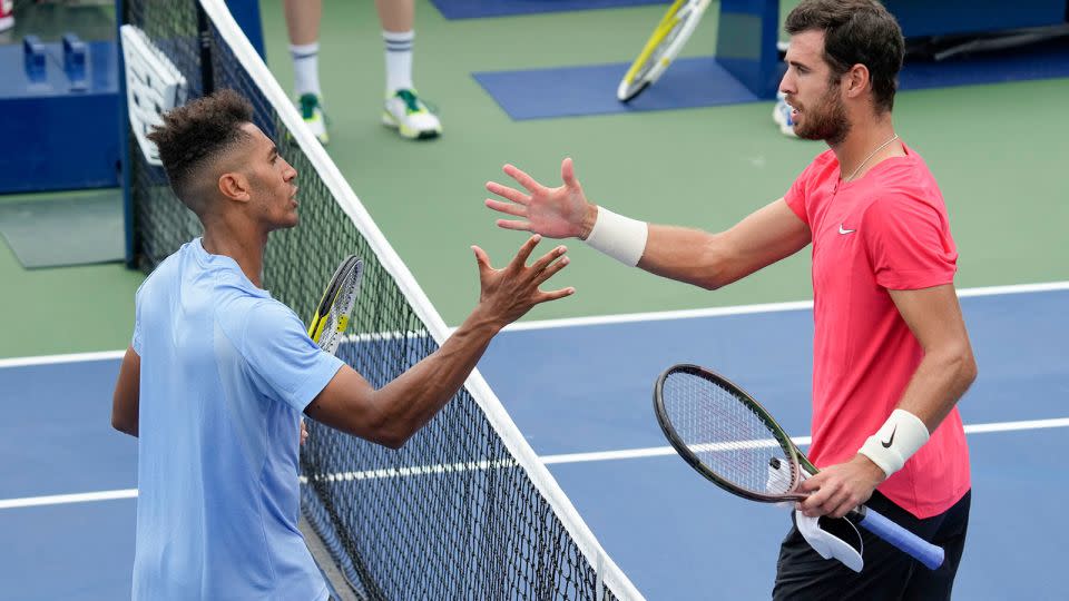 Michael Mmoh, left, produced a shock result after beating Karen Khachanov. - John Minchillo/AP