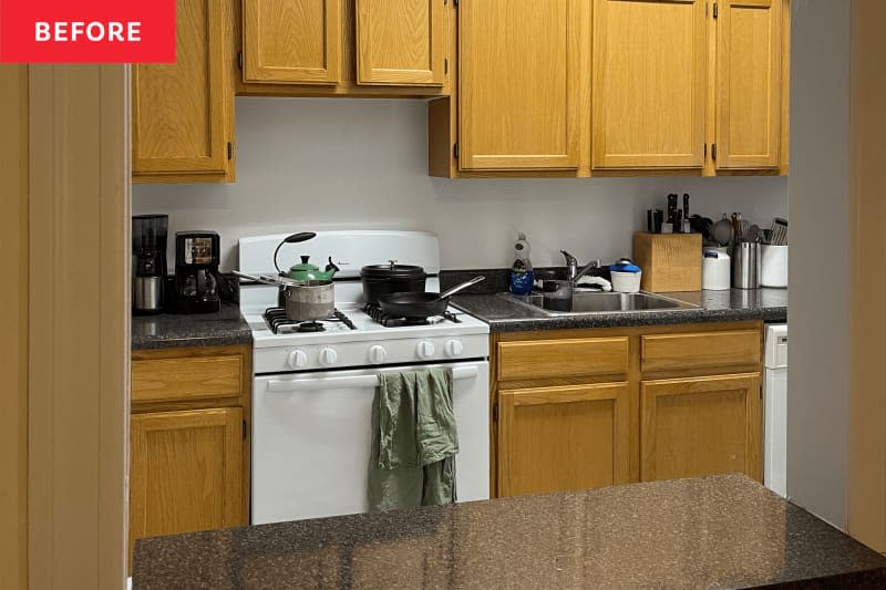 Before: kitchen with honey-toned wood cabinets and no hardware.