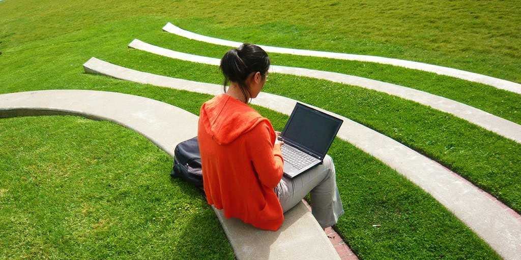 student studying laptop outside