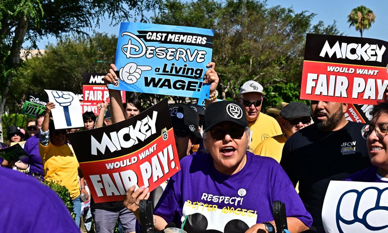 <span>Disney employees rally outside the Disneyland Resort in Anaheim, California, on 17 July 2024.</span><span>Photograph: Frederic J Brown/AFP/Getty Images</span>