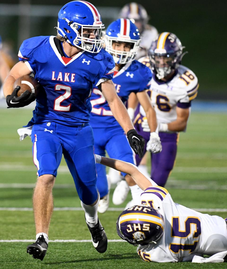 Lake tailback Nate Baker avoids a tackle by Jackson defensive back Cooper Geissinger for a first down to set up a second-quarter touchdown, Friday, Sept 22, 2023.