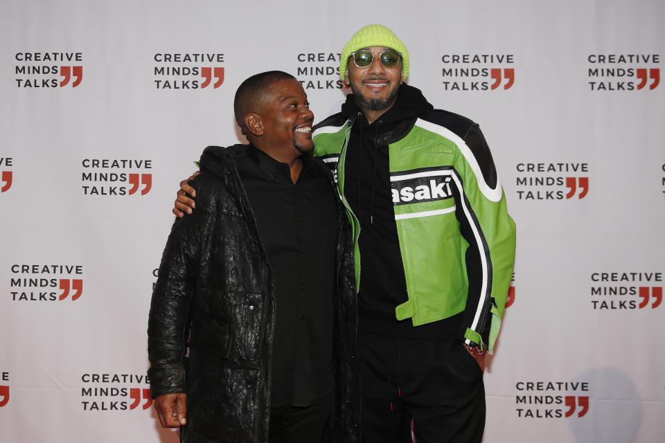 Kehinde Wiley and Swizz Beatz hug as they arrive during Art Basel, Monday, Dec. 2, 2019, in Miami Beach, Fla. (AP Photo/Brynn Anderson)