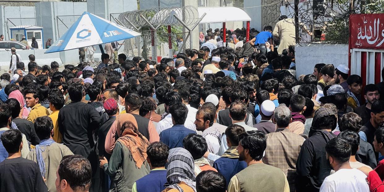 : Thousands of Afghans rush to the Hamid Karzai International Airport as they try to flee the Afghan capital of Kabul, Afghanistan, on August 16, 2021.