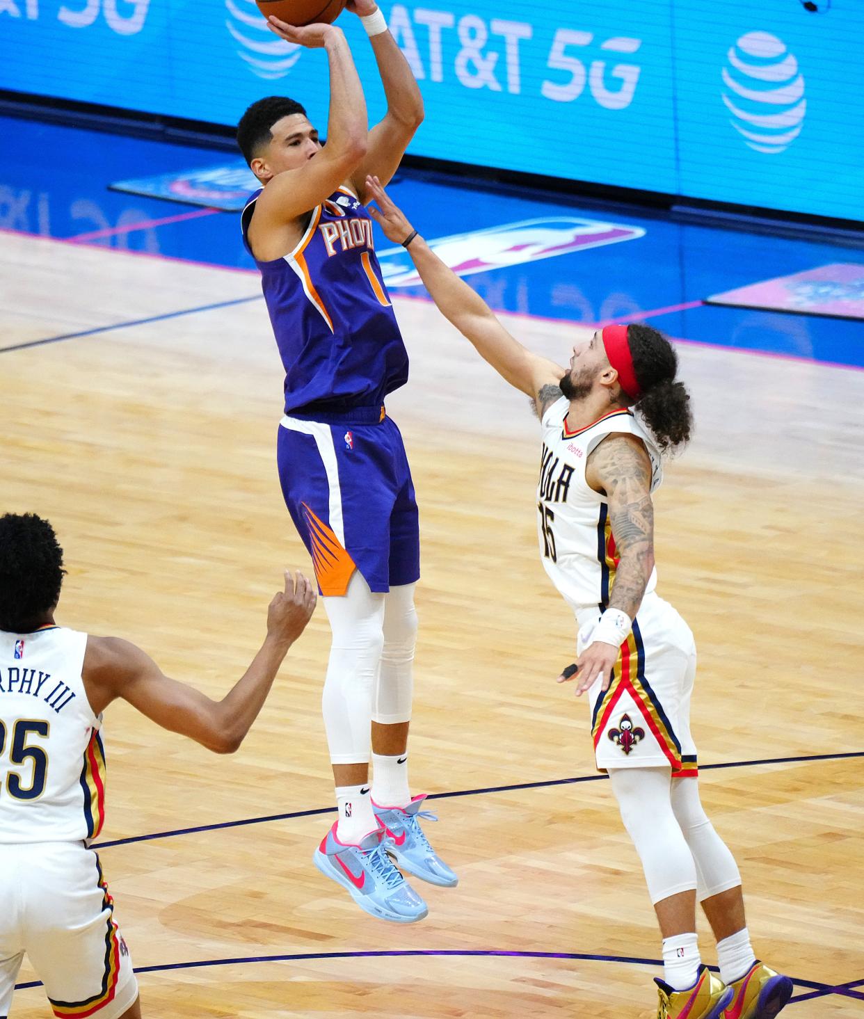 Suns' Devin Booker (1) shoots against Pelicans' Jose Alvarado (15) during Game 6 of the first round of the Western Conference Playoffs.