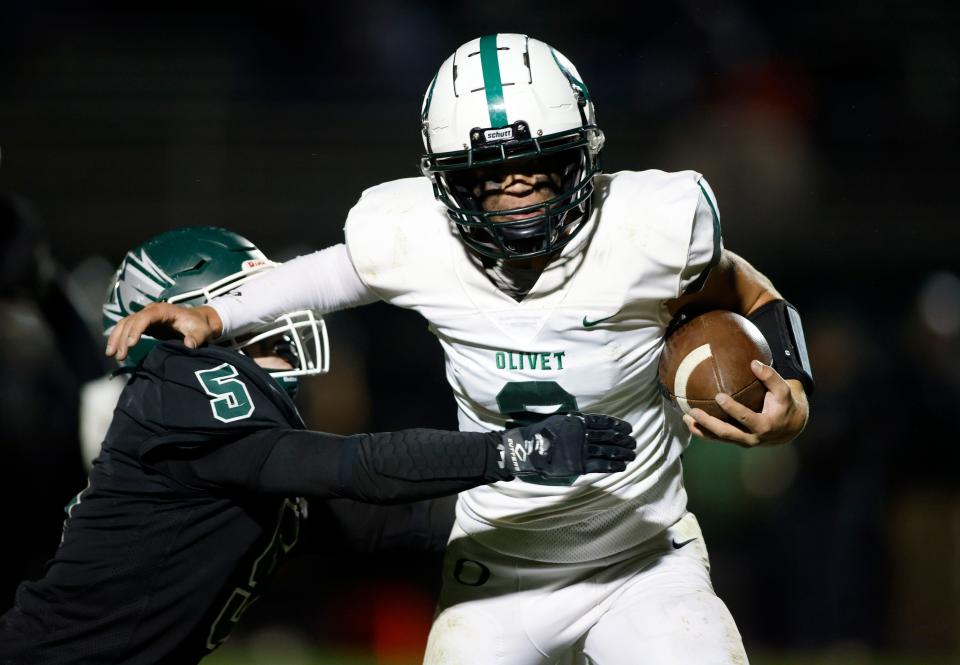 Olivet's Bo Lincoln, right, runs against Williamston's Oliver Brown, Friday, Oct. 14, 2022, in Williamston. Williamston won 29-22.