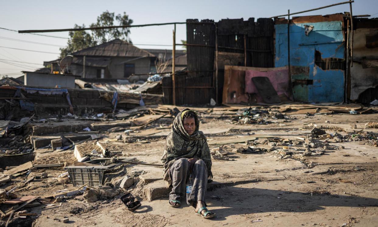 <span>A woman sits among the debris of demolished buildings in the historic Piassa neighbourhood of Addis Ababa. A government redevelopment project is transforming the area, and people are being forced to move.</span><span>Photograph: Michele Spatari/AFP/Getty Images</span>