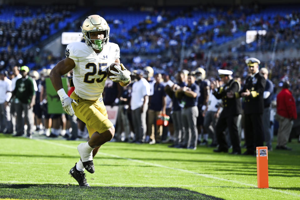 Notre Dame running back Chris Tyree (25) runs with the ball after making a catch for a touchdown during the first half of an NCAA college football game against Navy , Saturday, Nov. 12, 2022, in Baltimore. (AP Photo/Terrance Williams)