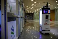 A self-driving robot sanitizes automated teller machines with UV light during its demonstration at the headquarters of SK Telecom in Seoul