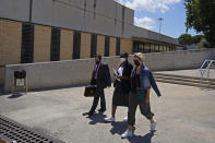 Lawyer Javier Villalba, left and John McAfee's wife Janice, centre, enter the Brians 2 penitentiary center with an unidentified woman in Sant Esteve Sesrovires, near Barcelona, northeast Spain, Friday, June 25, 2021. A judge in northeastern Spain has ordered an autopsy for John McAfee, creator of the McAfee antivirus software, a gun-loving antivirus pioneer, cryptocurrency promoter and occasional politician who died in a cell pending extradition to the United States for allegedly evading millions in unpaid taxes. McAfee's Spanish lawyer, Javier Villalba, said the entrepreneur's death had come as a surprise to his wife and other relatives, since McAfee "had not said goodbye." (AP Photo/Joan Mateu)
