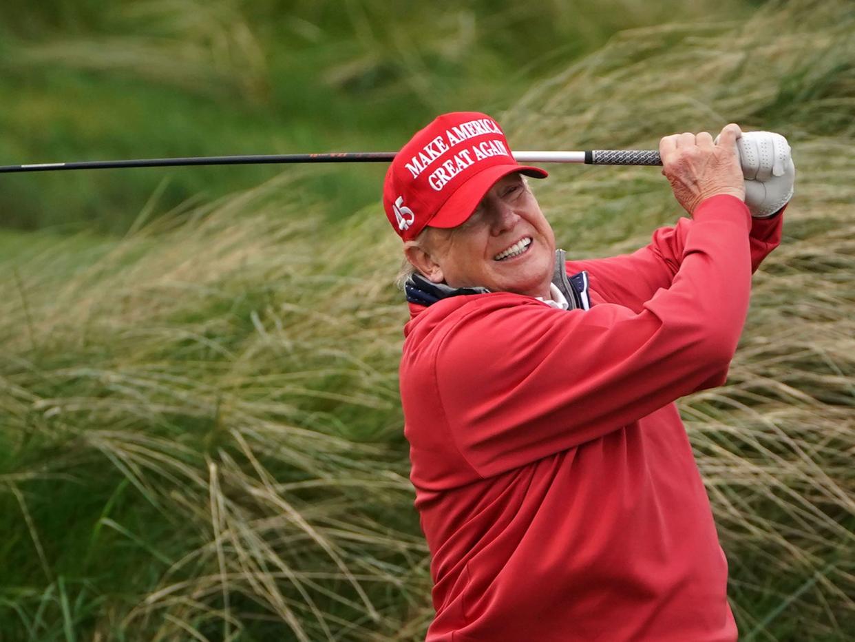 Donald Trump swinging a golf club