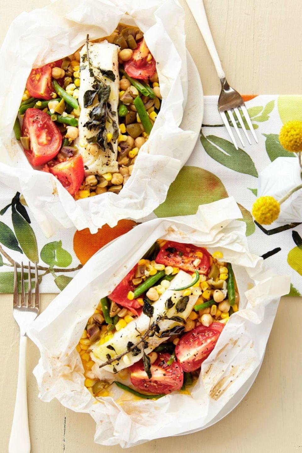 bass packets with tomato, corn, chickpeas, and olives