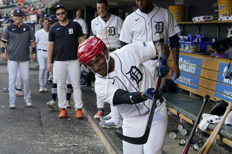 FILE - Detroit Tigers' Andy Ibanez shoots a goal in the dugout after his solo home run against the Texas Rangers, Tuesday, May 30, 2023, in Detroit. About half the clubs in MLB are using some kind of prop or ritual to celebrate a big hit or a big play in ways that often go viral. (AP Photo/Carlos Osorio, File)