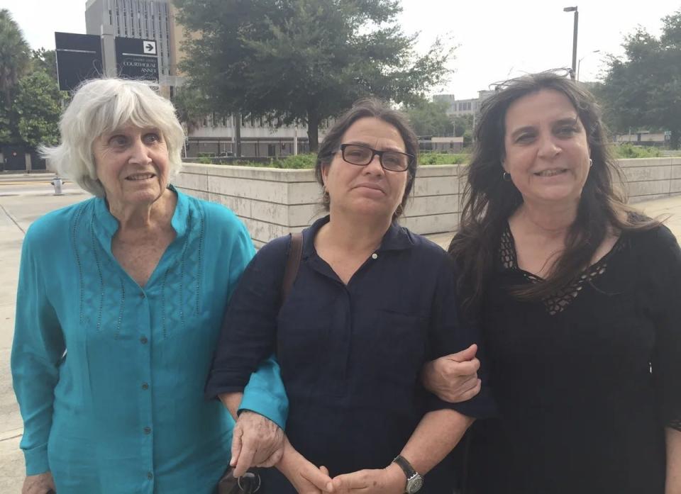 Joan Jara (in blue) and her daughters link arms outside a federal courthouse in Orlando in June 2016 after a jury found a former Chilean army lieutenant, Pedro Pablo Barrientos, responsible for the murder of Victor Jara in September 1973. The husband and father was murdered after a coup in the South American country of Chile.