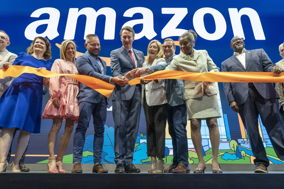 Virginia Gov. Glenn Youngkin, center, with Holly Sullivan, Vice President of Economic Development at Amazon, center right, cut the ribbon during a grand opening ceremony at Amazon's second headquarters, HQ2, in Arlington, Va., Thursday, June 15, 2023. From right, Christian Dorsey, Chair of the Arlington County Board of Directors, Lieutenant Gov. of Virginia Winsome Earle-Sears, John Schoettler, Vice President of Global Real Estate and Facilities at Amazon, Holly Sullivan, Gov. Glenn Youngkin, Brian Huseman, Vice President of Public Policy and Community Engagement at Amazon, and Youngkin's wife Suzanne Youngkin. (AP Photo/Jacquelyn Martin)