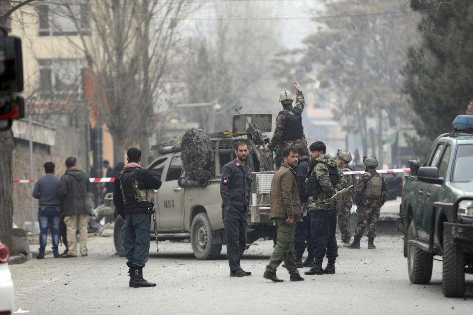 Security personnel inspect the site of a bomb attack in Kabul, Afghanistan, Saturday, Feb. 20, 2021. Three separate explosions in the capital Kabul on Saturday killed and wounded numerous people an Afghan official said. (AP Photo/Rahmat Gul)