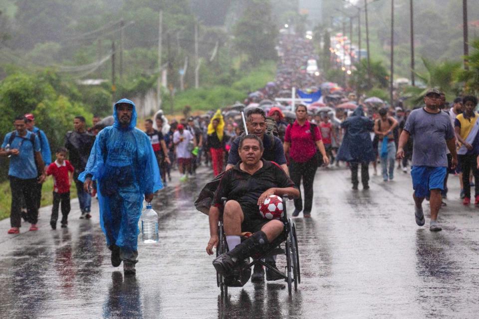 A migrant in a wheelchair holds a ball as he is pushed by a fellow migrant, during a caravan to cross the country to reach the U.S. border, as regional leaders gather in Los Angeles to discuss migration and other issues, in Tapachula, Mexico June 6, 2022. REUTERS/Quetzalli Nicte-Ha (REUTERS)