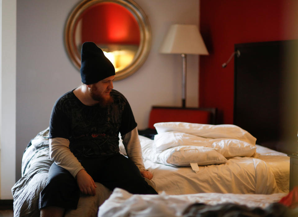 Travis Johnson sits on his bed in his room at the Red Lion Hotel, one of Downtown Emergency Service Center's temporary shelter locations during the coronavirus outbreak. (Photo: Lindsey Wasson/Reuters)