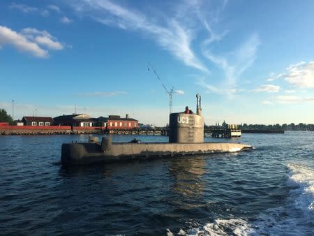 An unidentified woman stands in the tower of the private submarine "UC3 Nautilus" pictured in Copenhagen Harbor, Denmark August 11, 2017. Picture taken August 11, 2017. Anders Valdsted/Scanpix Denmark via REUTERS