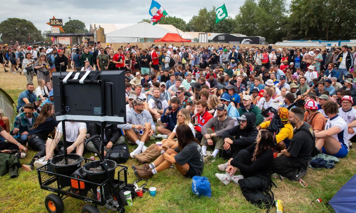 <span>England fans watching the match against Slovakia on a small TV screen at Glastonbury.</span><span>Photograph: Jonny Weeks/The Guardian</span>