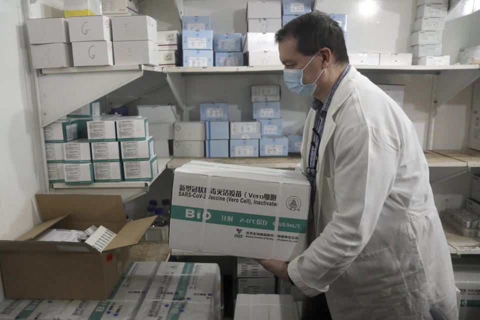 Public health employee Sandor Kaizler packs up newly arrived packets containing Chinese Sinopharm vaccines at the Public Health Department of the Borsod-Abauj-Zemplen County Government Office in Miskolc, Hungary, Wednesday, March 3, 2021. (Janos Vajda/MTI via AP)