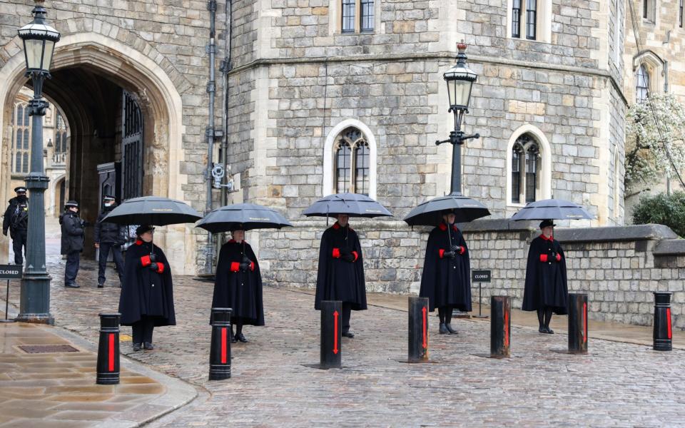  Windsor Castle Wardens stand guard outside the castle as rain begins to fall on April 12, 2021 in Windsor, England. - Chris Jackson/Getty 