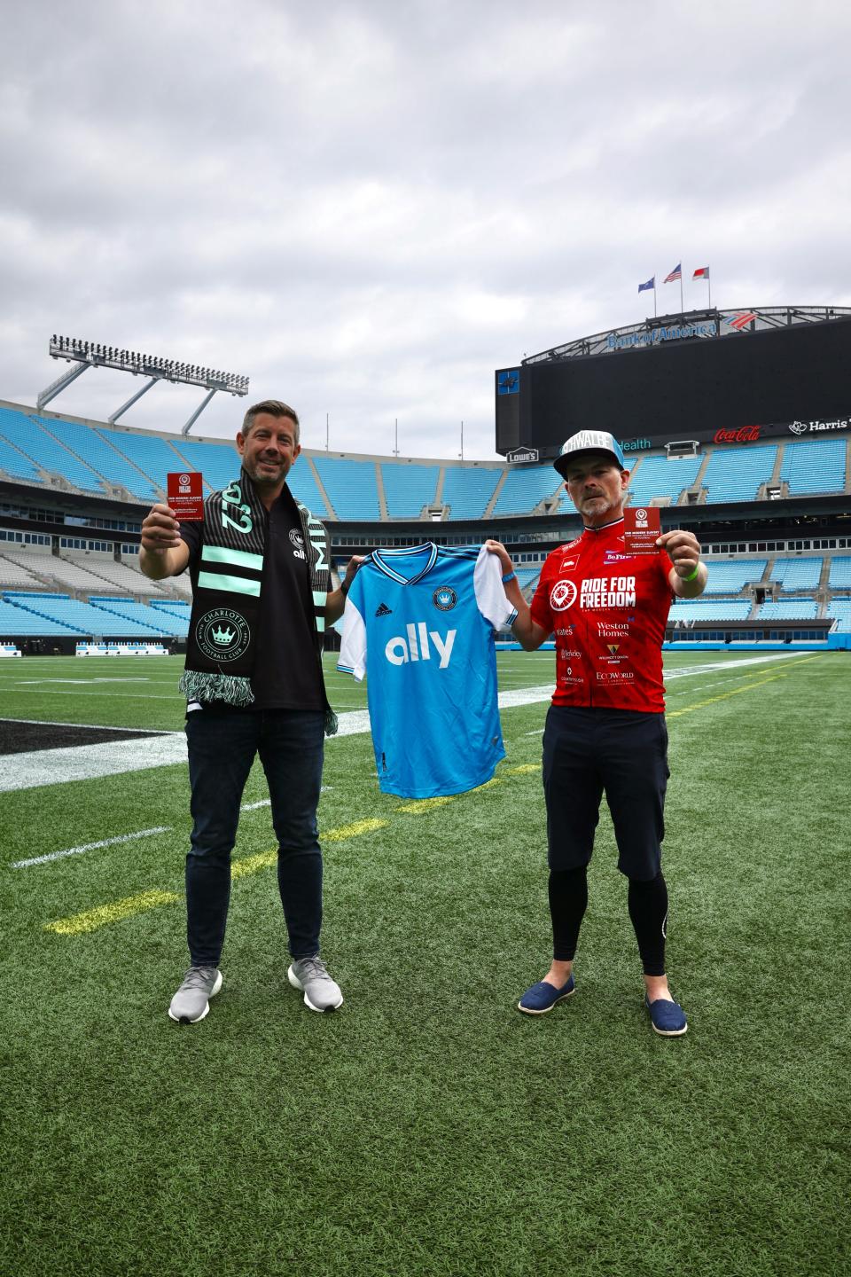 Two men holding a t-shirt