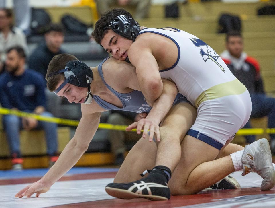 Freehold's Angelo Messina (top) made it seven district titles for his family by winning the 138-pound title at the District 22 Tournament.