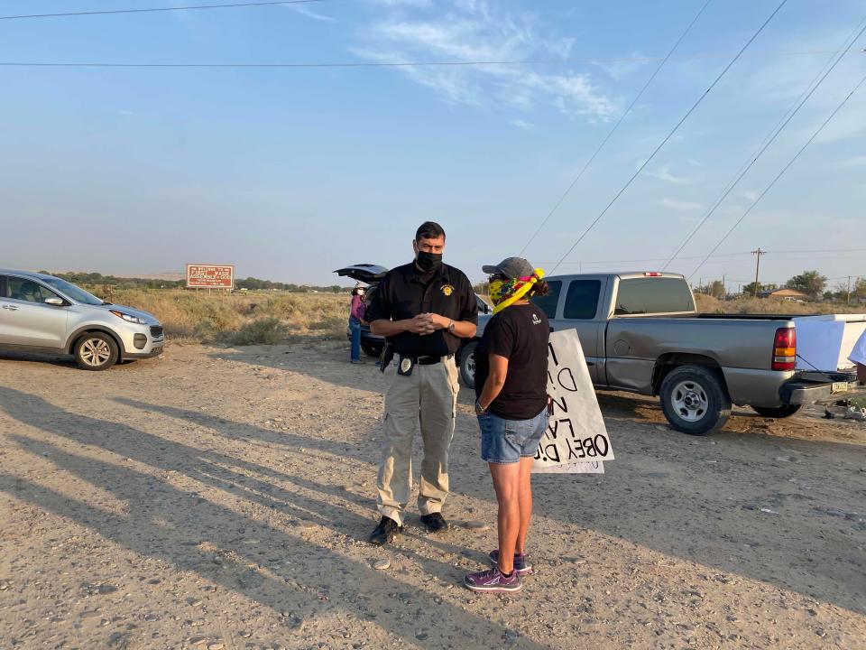 Former Navajo Nation Chief of Police Phillip Francisco, in 2020, talks with protesters who picketed in front of the road that led to a marijuana farm in Shiprock.