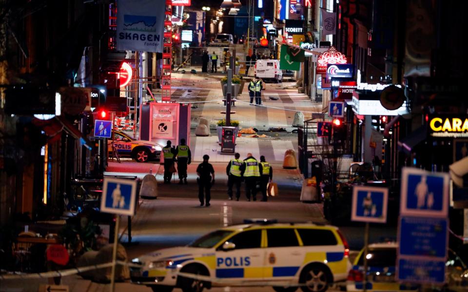 Police work at the scene into the night at the scene of the Stockholm attack - Credit: Odd Andersen/AFP