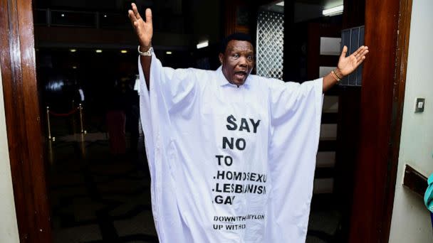 PHOTO: Member of Parliament John Musira dressed in an anti gay gown gestures as he leaves the chambers during the debate of Uganda's Anti-Homosexuality bill, in Kampala, Uganda, March 21, 2023. (Abubaker Lubowa/Reuters)