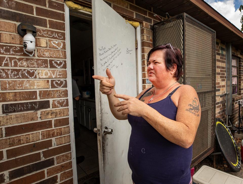 Tina Smith stands outside the door of her apartment on Iowa Street on Jan. 31, 2023, as she describes the shooting that occurred the day before. Eleven people were wounded in the shooting, which took place barely a minute after children were dropped off by a school bus. No children were among the wounded.