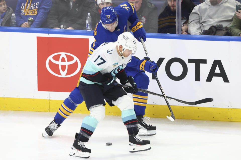 Buffalo Sabres right wing Tage Thompson (72) and Seattle Kraken center Jaden Schwartz (17) vie for the puck during the third period of an NHL hockey game Tuesday, Jan. 9, 2024, in Buffalo, N.Y. (AP Photo/Jeffrey T. Barnes)