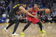 Portland Trail Blazers guard Dennis Smith Jr., right, is defended by Golden State Warriors guard Jordan Poole during the first half of an NBA basketball game in San Francisco, Wednesday, Dec. 8, 2021. (AP Photo/Jeff Chiu)