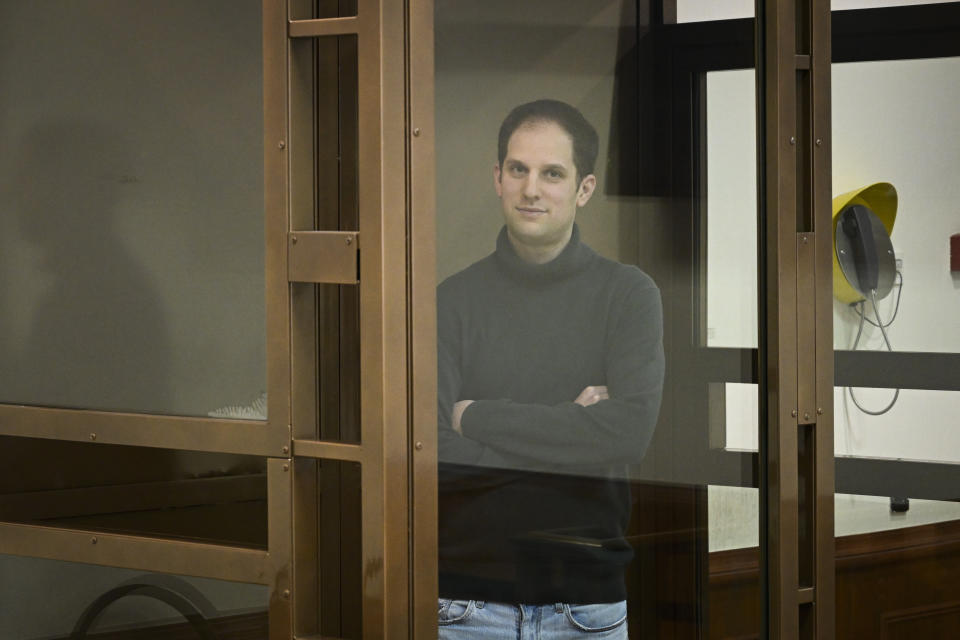 Wall Street Journal reporter Evan Gershkovich stands in a glass cage in a courtroom at the Moscow City Court, in Moscow, Russia, on Thursday, Dec. 14, 2023. Wall Street Journal reporter Evan Gerhskovich, arrested in Russia on espionage charges, will remain in detention until Jan. 30, a court in Moscow ruled on Thursday. The hearing took place behind closed doors because authorities say details of the criminal case against the American journalist are classified. (AP Photo/Dmitry Serebryakov)