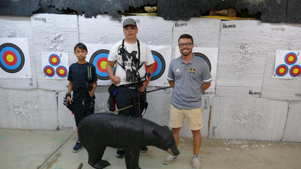 2 out of 4 of the Archery Manitoba team with Head Coach Matthew Trudeau