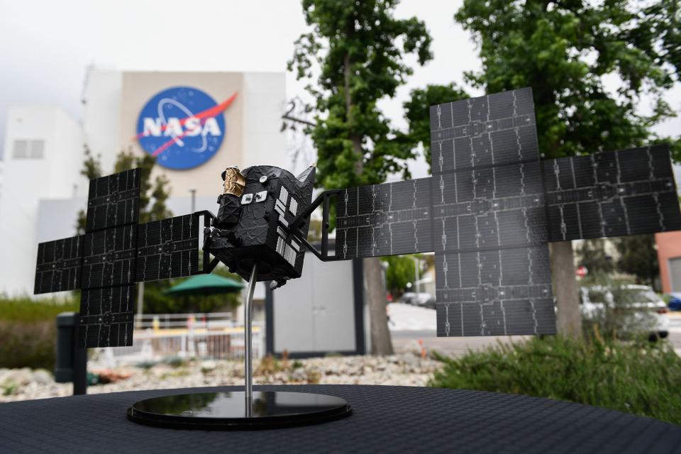 A 1:24th scale model of the Psyche spacecraft is displayed at NASA's Jet Propulsion Laboratory in Pasadena, California, on April 11, 2022. The orbiter will launch from Cape Canaveral, Florida, in October and journey 2.5 billion miles (4 billion kilometers) to a metal-rich asteroid that NASA says may tell us more about planetary cores and how planets form.