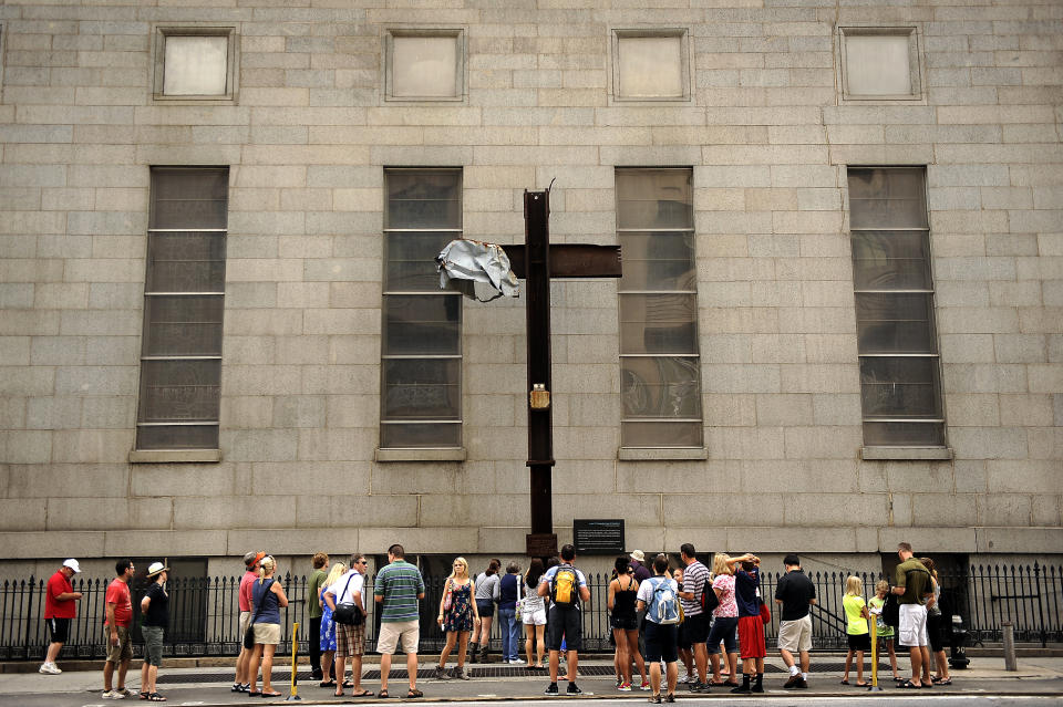 The Cross at Ground Zero was moved to St. Peter's Church on October 5, 2006. Visitors pass by on Church Street between Barclay and Vesey Streets. A welded steel plaque reads 'The Cross at Ground Zero - Founded September 13, 2001; Blessed October 4, 2001; Temporarily Relocated October 5, 2006. Will return to WTC Museum, a sign of comfort for. Joe Amon, The Denver Post  (Photo By Joe Amon/The Denver Post via Getty Images)