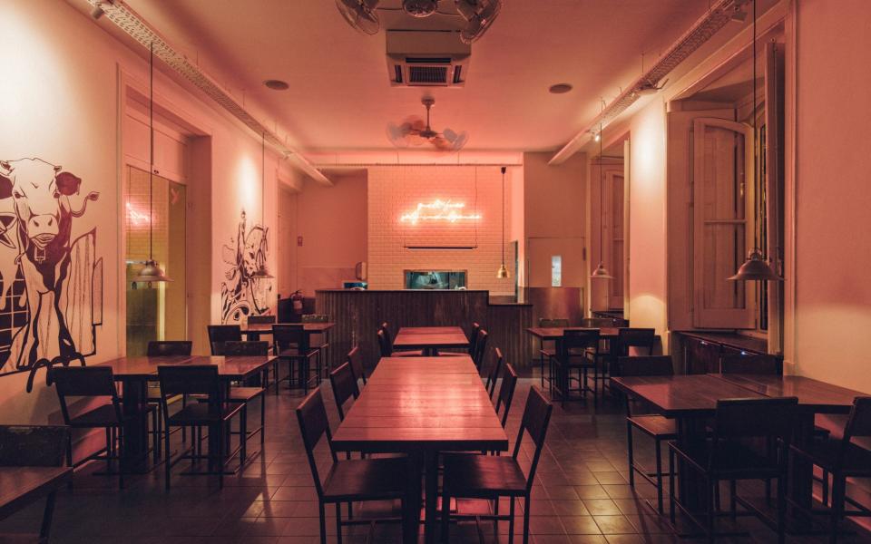 dining room with pink uplighting and neon sign - Miguel Guedes Ramos 