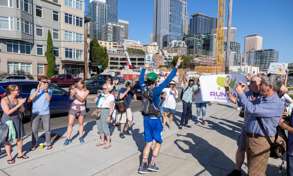 Greg Nance jogs toward a group of supporters waiting for him on the Seattle waterfront on July 13.